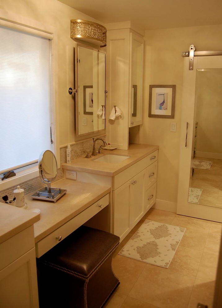 Mid-sized transitional master bathroom in Orange County with an undermount sink, shaker cabinets, white cabinets, limestone benchtops, a one-piece toilet, beige tile, stone tile, beige walls and travertine floors.