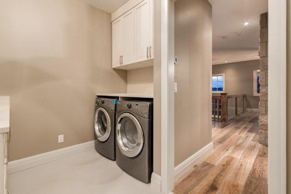 Design ideas for a transitional laundry room in Calgary.