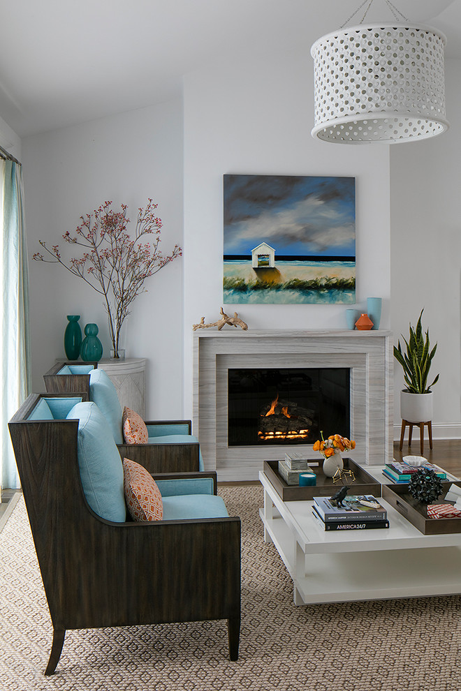 This is an example of a transitional open concept living room in San Francisco with carpet, a standard fireplace, a stone fireplace surround and beige floor.