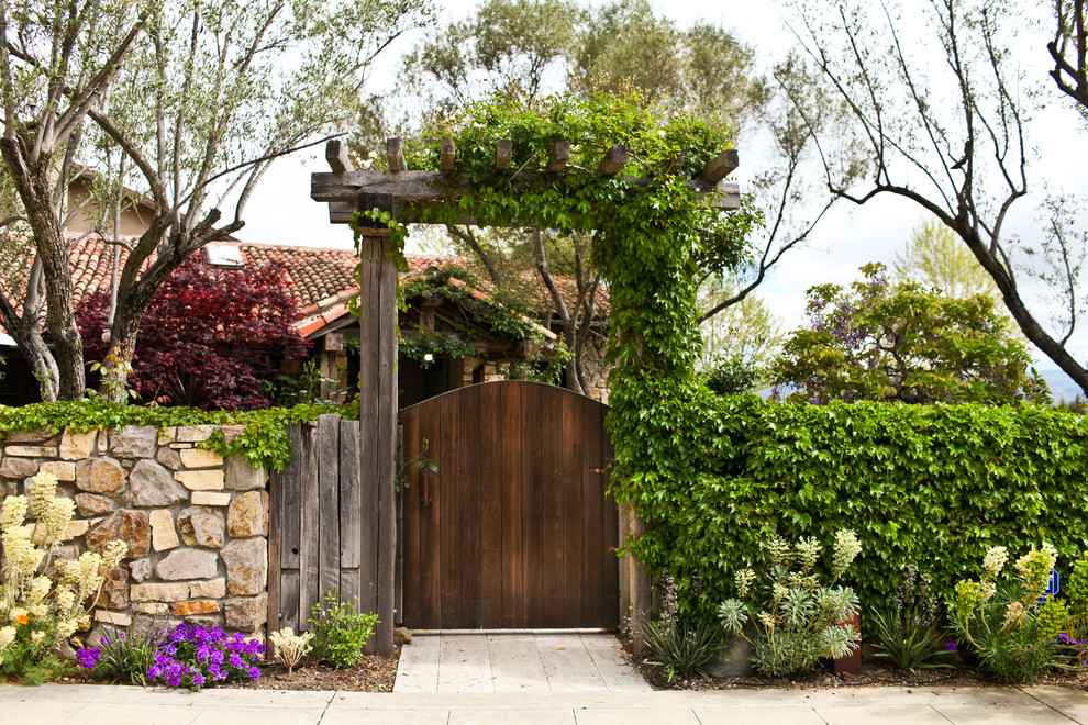 Inspiration for a mid-sized mediterranean front yard full sun garden for spring in San Francisco with natural stone pavers and a garden path.