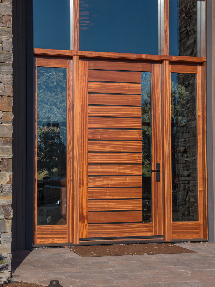 Inspiration for an expansive transitional front door in Other with a single front door and a medium wood front door.
