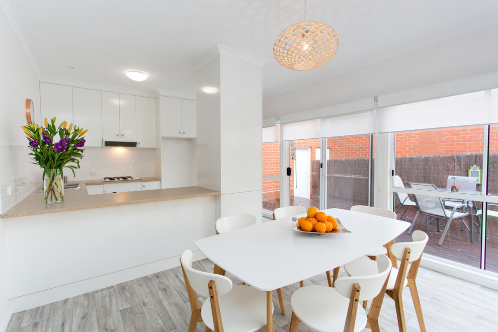 Inspiration for a small contemporary separate dining room with grey walls and vinyl floors.