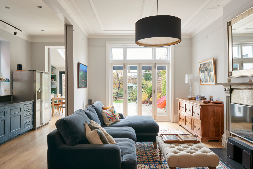 Inspiration for a traditional open plan living room in London with grey walls, medium hardwood flooring and brown floors.