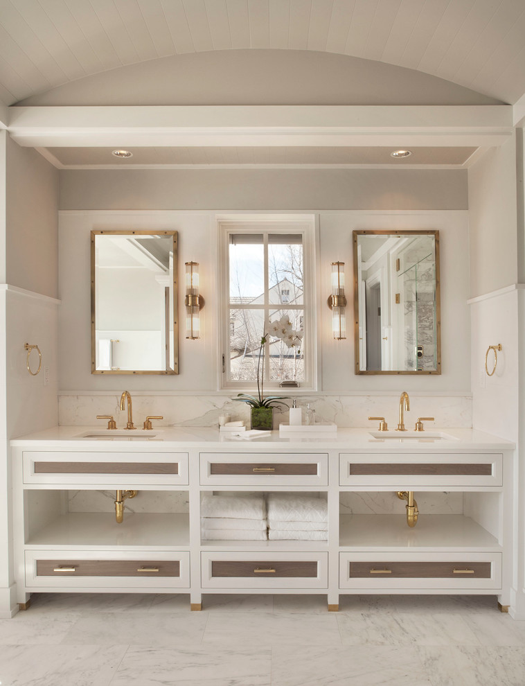 Photo of a beach style bathroom in New York with marble floors and recessed-panel cabinets.