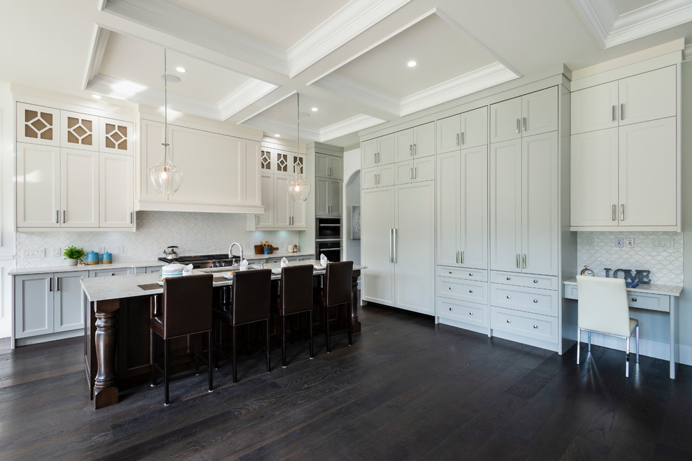 Inspiration for an expansive traditional l-shaped open plan kitchen in Vancouver with an undermount sink, recessed-panel cabinets, dark wood cabinets, granite benchtops, white splashback, porcelain splashback, stainless steel appliances, dark hardwood floors, with island, black floor and grey benchtop.