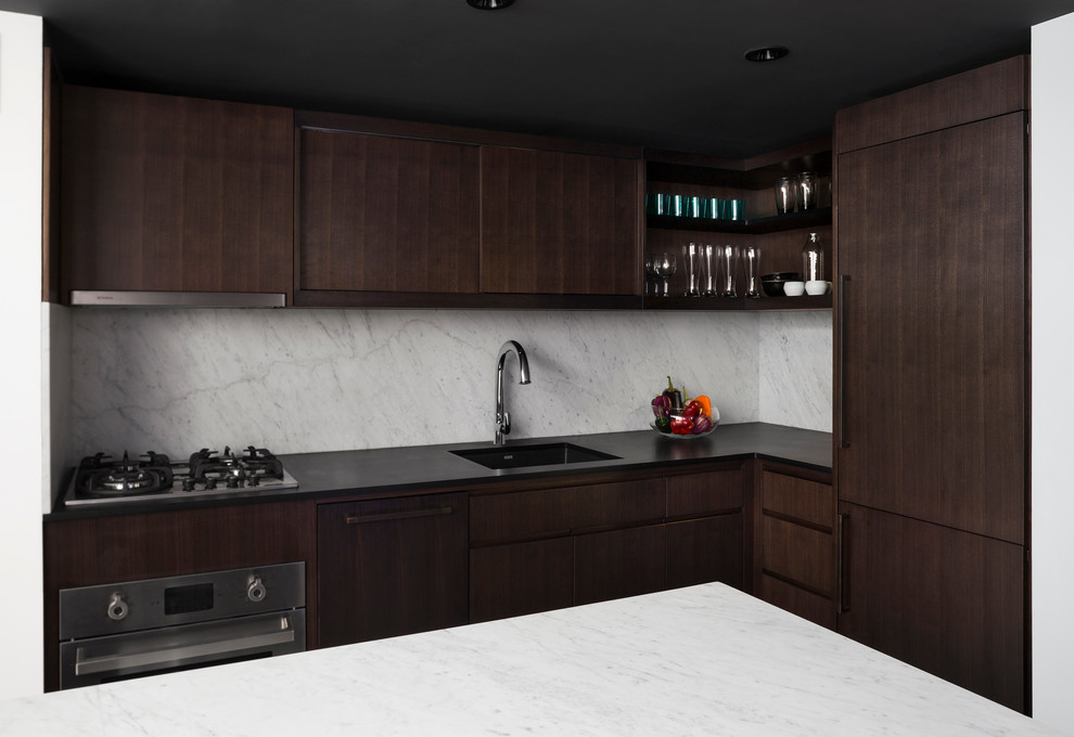 Example of a small trendy l-shaped porcelain tile kitchen design in New York with an undermount sink, flat-panel cabinets, dark wood cabinets, stone slab backsplash, stainless steel appliances and an island