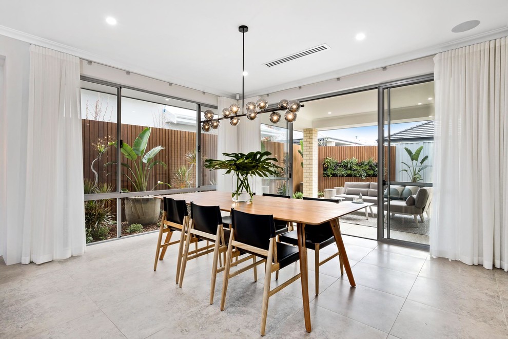 Photo of a mid-sized contemporary open plan dining in Perth with beige walls and beige floor.