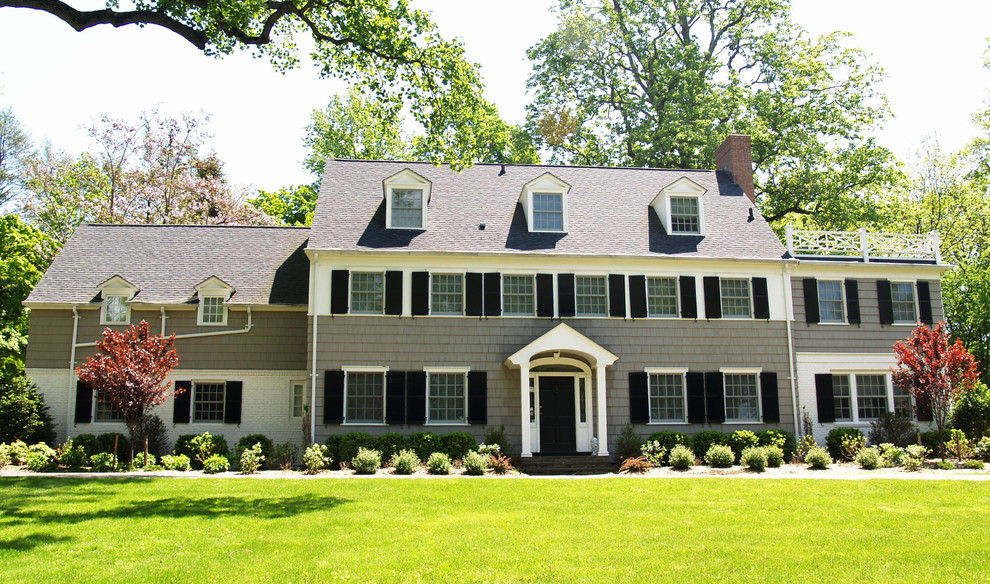 Mid-sized traditional three-storey grey house exterior in New York with wood siding, a gable roof and a shingle roof.