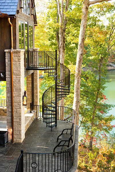 Inspiration for a mid-sized transitional metal spiral staircase in Other with open risers and metal railing.