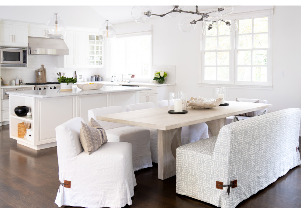 Inspiration for a beach style dining room in Orange County with white walls, dark hardwood floors and brown floor.