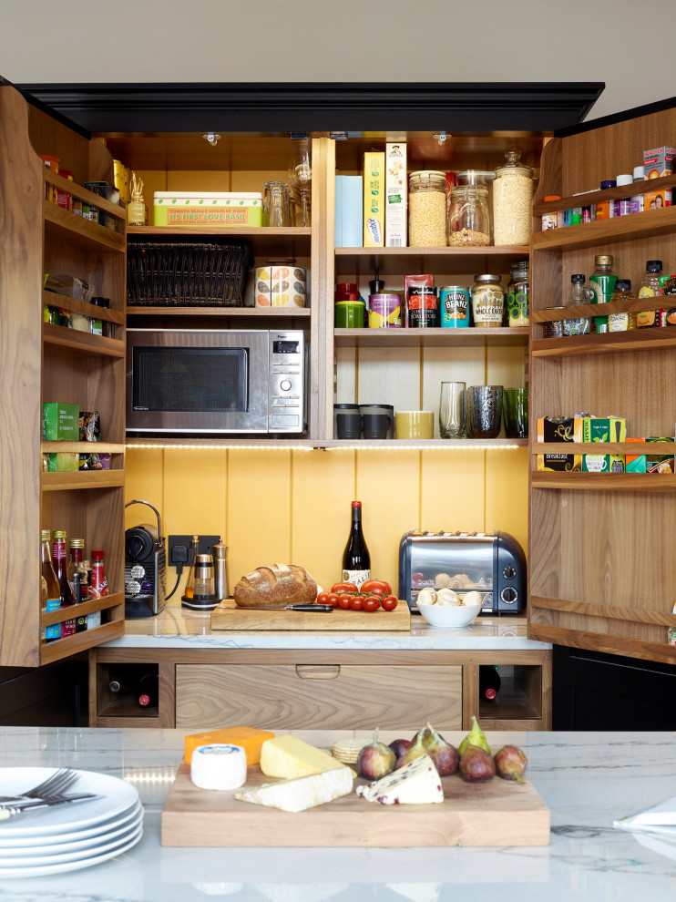 Photo of a contemporary galley kitchen/diner with shaker cabinets, black cabinets, granite worktops, an island and white worktops.