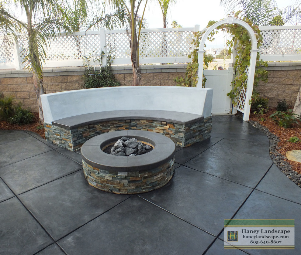 This is an example of a small contemporary backyard patio in Santa Barbara with a fire feature and stamped concrete.