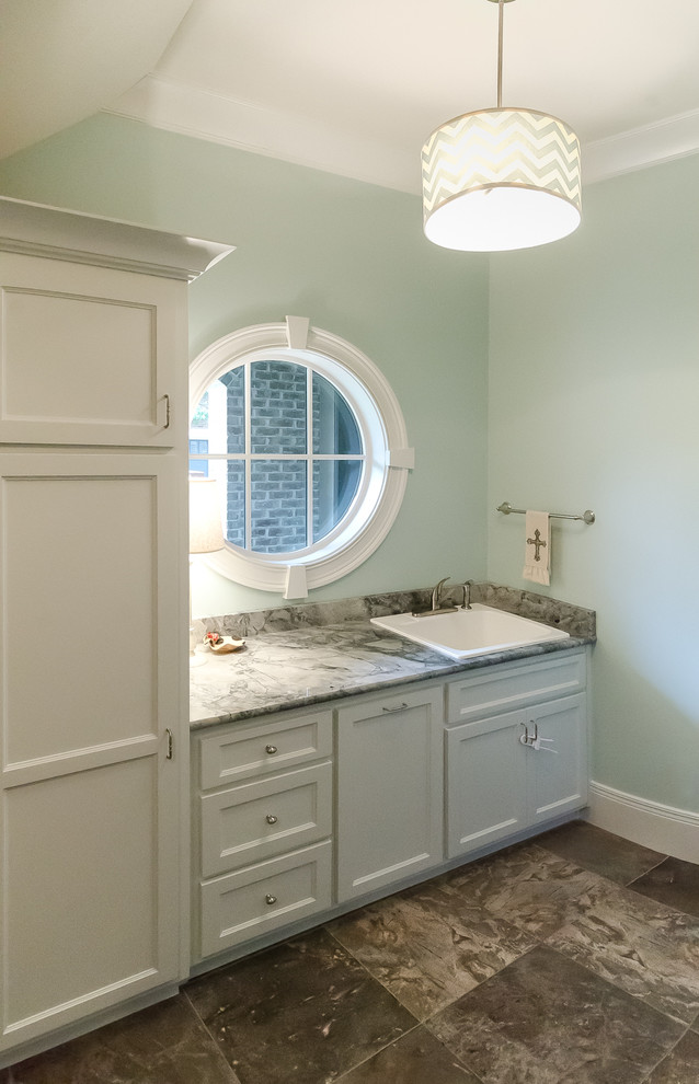 Photo of a traditional laundry room in Birmingham with a drop-in sink and blue walls.