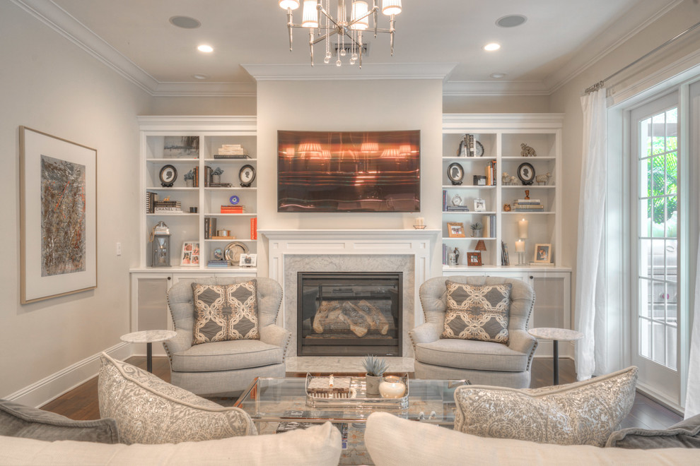 Inspiration for a large transitional open concept living room in Tampa with beige walls, medium hardwood floors, a standard fireplace, a stone fireplace surround, a wall-mounted tv and brown floor.