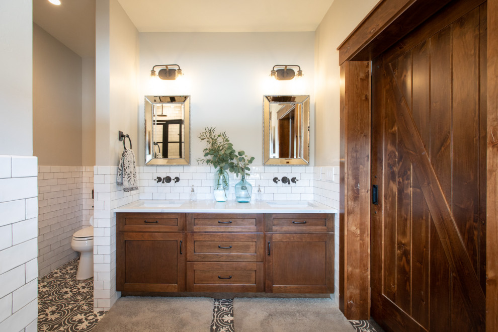 Mid-sized country master bathroom in Portland with shaker cabinets, dark wood cabinets, white tile, subway tile, grey walls, ceramic floors, an undermount sink, engineered quartz benchtops, multi-coloured floor and white benchtops.