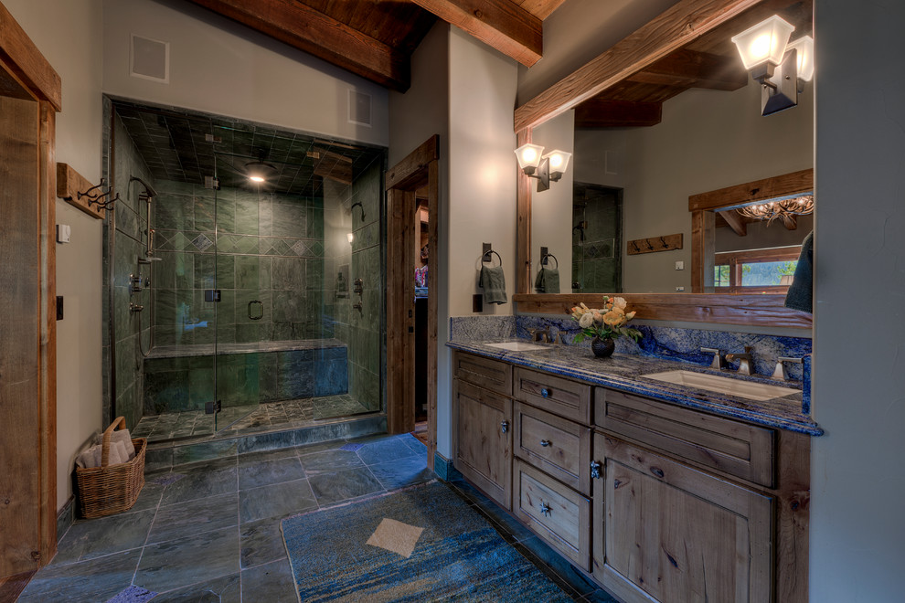 Inspiration for a large country master bathroom in Sacramento with shaker cabinets, medium wood cabinets, an alcove shower, gray tile, grey walls, an undermount sink, a drop-in tub, a two-piece toilet, ceramic floors, solid surface benchtops, a hinged shower door and grey floor.