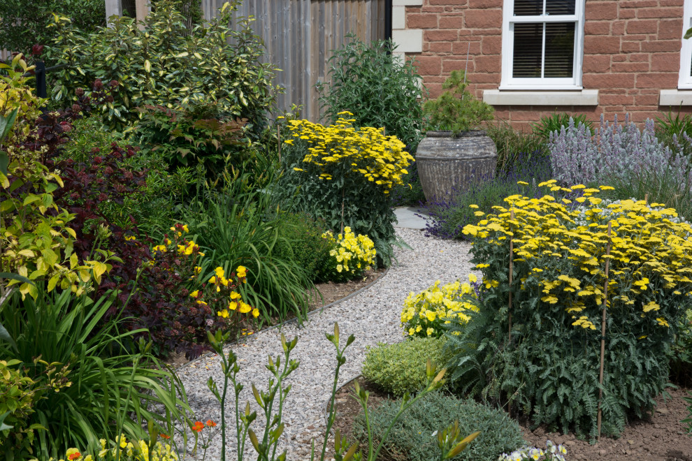 Inspiration for a mid-sized country front yard full sun driveway for summer in Other with a garden path and gravel.