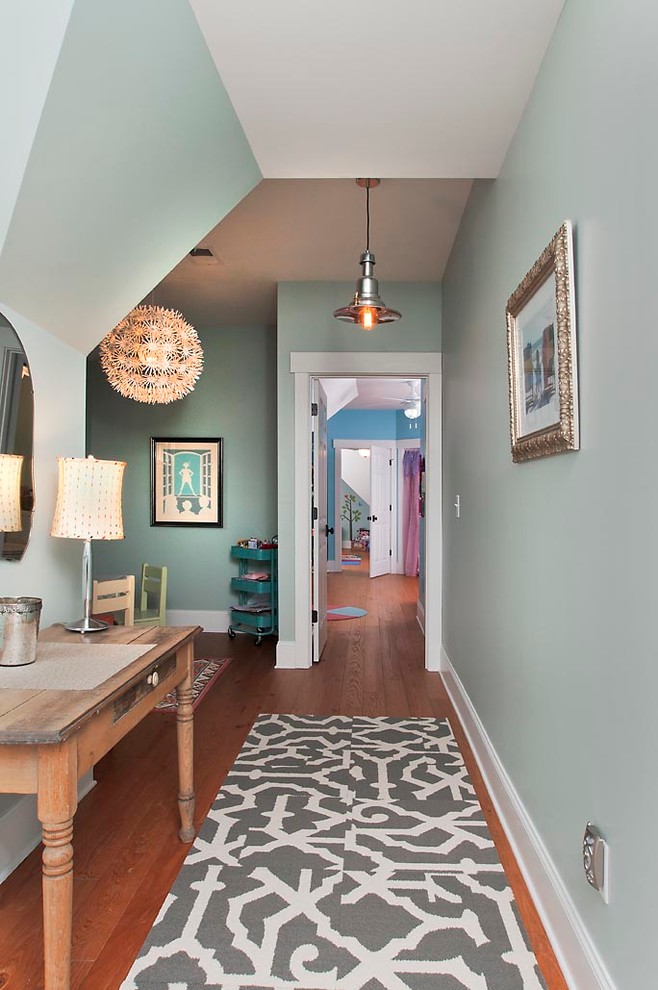 Inspiration for a traditional hallway in Atlanta with blue walls and medium hardwood floors.