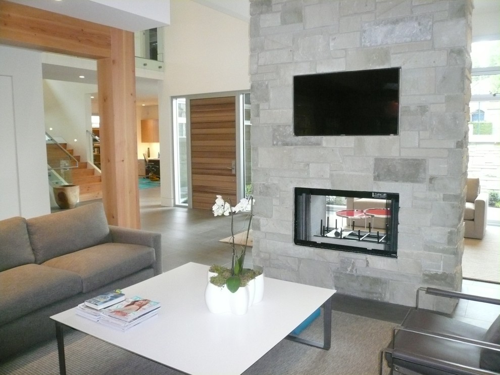 This is an example of an expansive contemporary open concept family room in Vancouver with a built-in media wall.