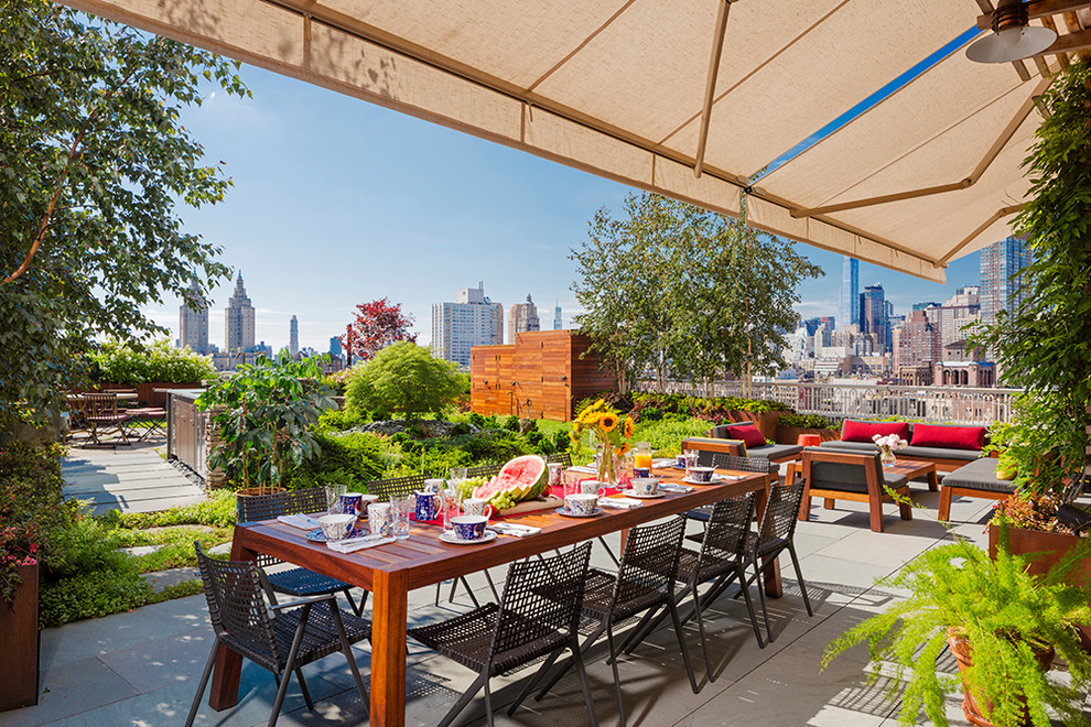 Photo of a large contemporary rooftop and rooftop deck in New York with an awning.