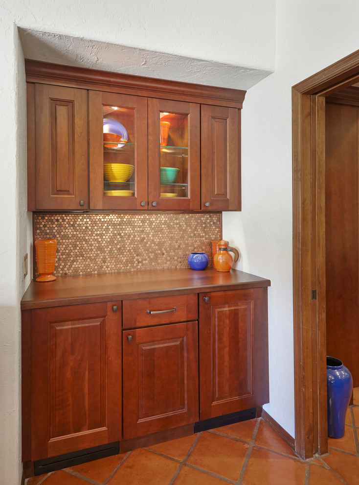 Large traditional u-shaped eat-in kitchen in Phoenix with an undermount sink, raised-panel cabinets, medium wood cabinets, granite benchtops, blue splashback, glass tile splashback, stainless steel appliances, terra-cotta floors, with island and brown floor.