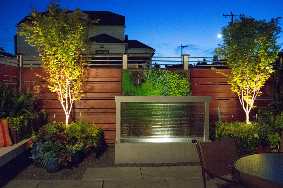 Small contemporary backyard partial sun outdoor sport court in Seattle with natural stone pavers for summer.