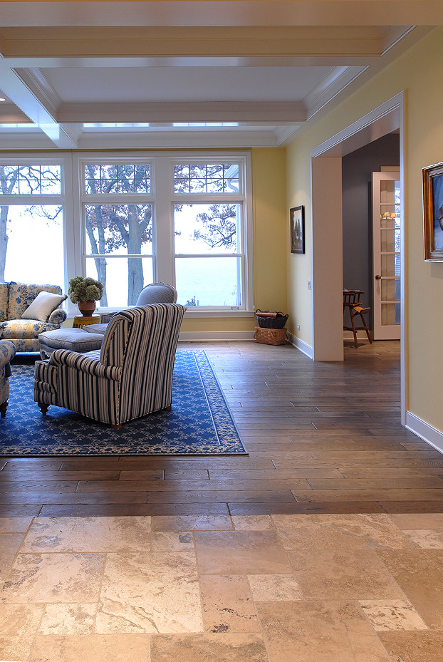Example of a large tuscan medium tone wood floor, brown floor and coffered ceiling living room design in Chicago