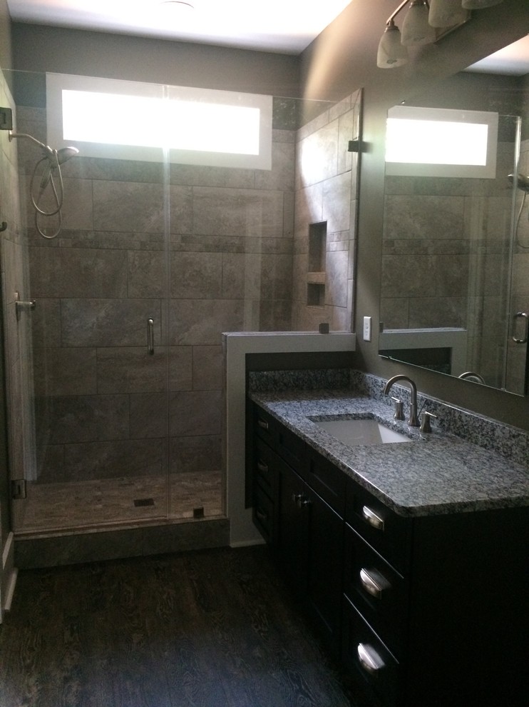 Mid-sized transitional 3/4 beige tile and ceramic tile dark wood floor doorless shower photo with shaker cabinets, dark wood cabinets, an undermount sink, granite countertops and green walls