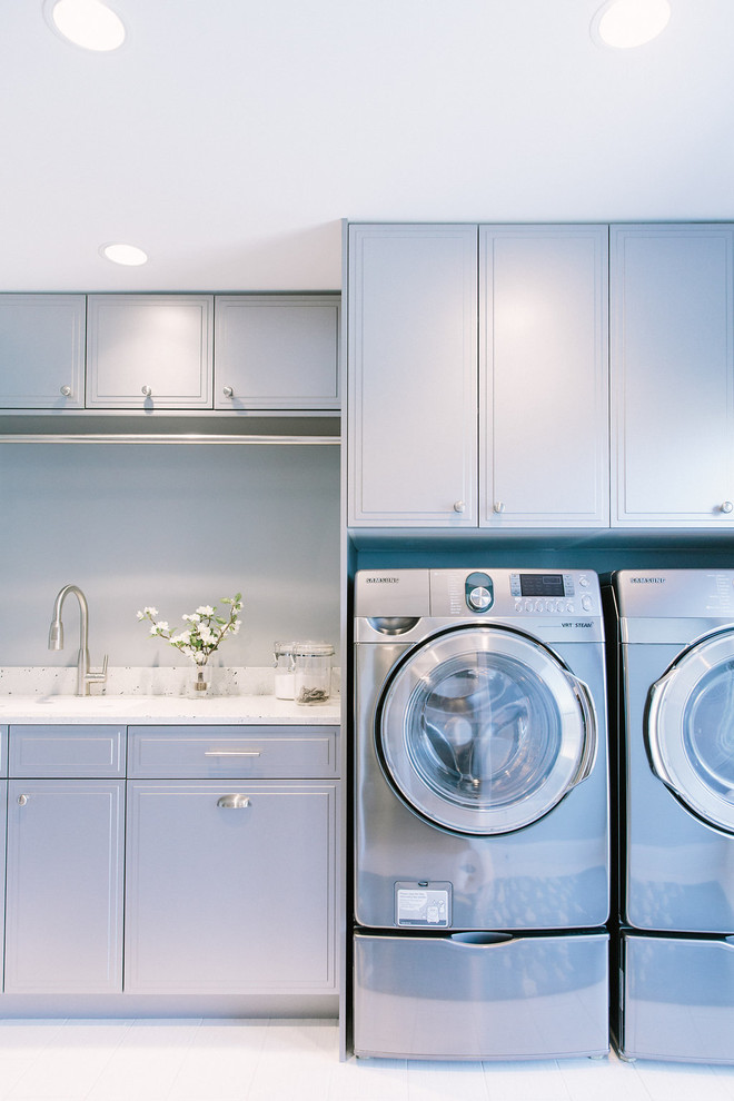 Inspiration for a transitional laundry room in Portland Maine with recycled glass benchtops, porcelain floors and grey cabinets.