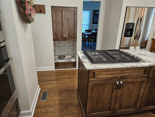 After: The niche was extended to the floor to create a built-in feeding station for the family’s dog, blending seamlessly into the kitchen design.