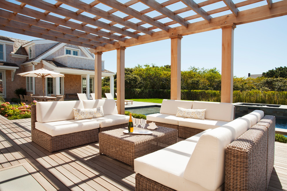 Traditional backyard deck in Providence with a pergola.