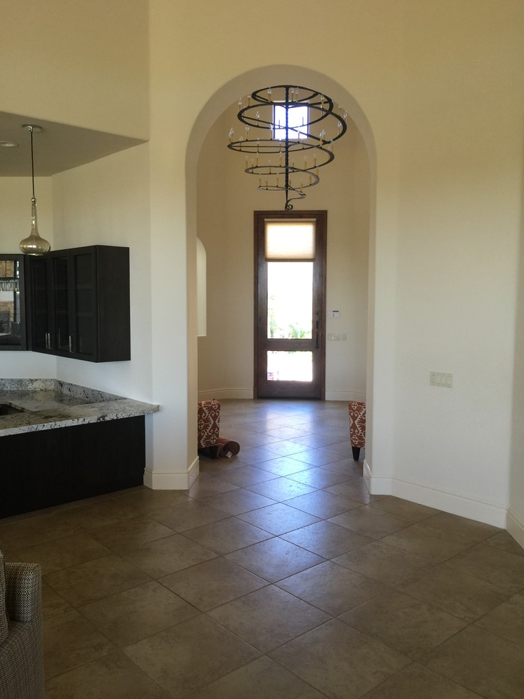 Example of a large transitional ceramic tile foyer design with beige walls and a medium wood front door