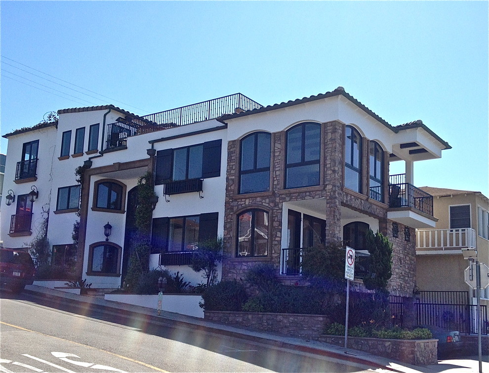Tuscan white three-story mixed siding exterior home photo