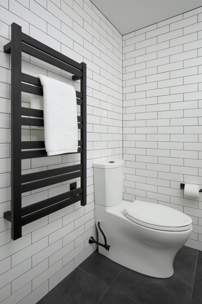 This is an example of a mid-sized contemporary master bathroom in Boston with a two-piece toilet, white tile, subway tile, white walls, ceramic floors and grey floor.