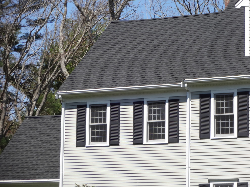 Large traditional three-storey beige exterior in Providence with vinyl siding and a gable roof.