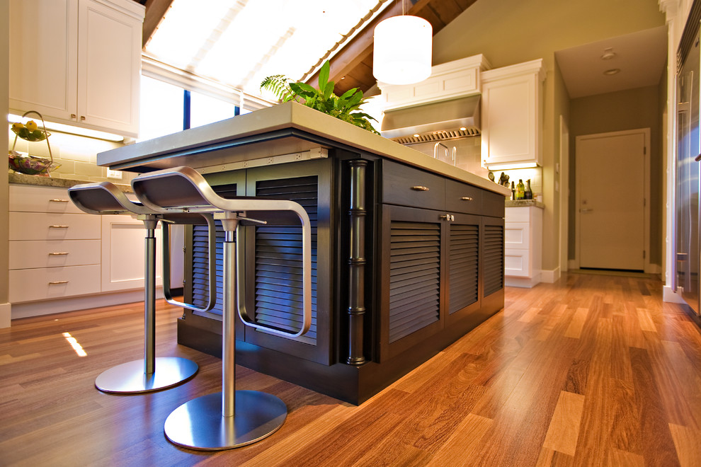 Photo of a large contemporary u-shaped eat-in kitchen in San Francisco with an undermount sink, louvered cabinets, dark wood cabinets, quartzite benchtops, subway tile splashback, stainless steel appliances and medium hardwood floors.