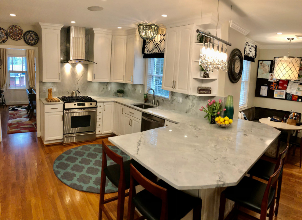 Eat-in kitchen - mid-sized transitional u-shaped medium tone wood floor and brown floor eat-in kitchen idea in DC Metro with an undermount sink, recessed-panel cabinets, white cabinets, quartzite countertops, white backsplash, quartz backsplash, stainless steel appliances, an island and white countertops