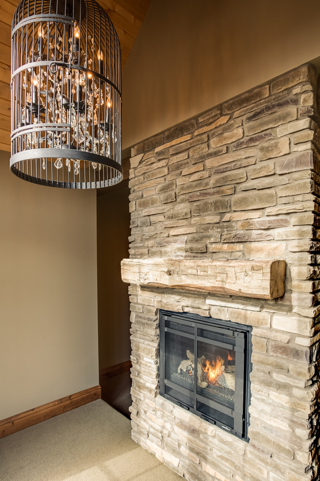 Inspiration for a mid-sized rustic master carpeted home design remodel with beige walls, a two-sided fireplace and a stone fireplace