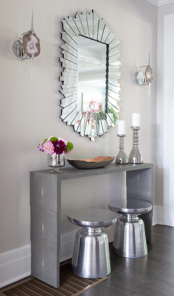 Example of a small beach style medium tone wood floor and brown floor foyer design in New York with gray walls