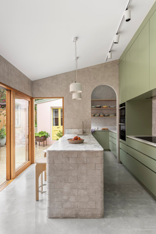 Contemporary kitchen pantry in Sydney with an undermount sink, green cabinets, marble benchtops, marble splashback, stainless steel appliances, concrete floors, a peninsula and grey floor.