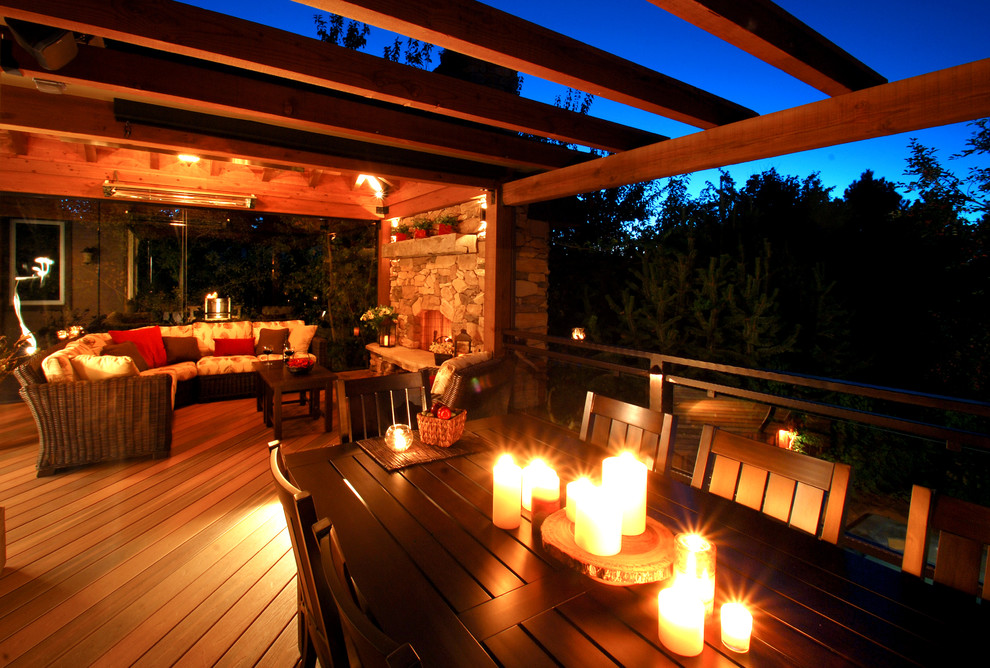Inspiration for a large country backyard deck with a pergola and a fire feature.