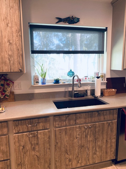 Inspiration for a large l-shaped eat-in kitchen remodel with an undermount sink, flat-panel cabinets, medium tone wood cabinets, stainless steel appliances and an island