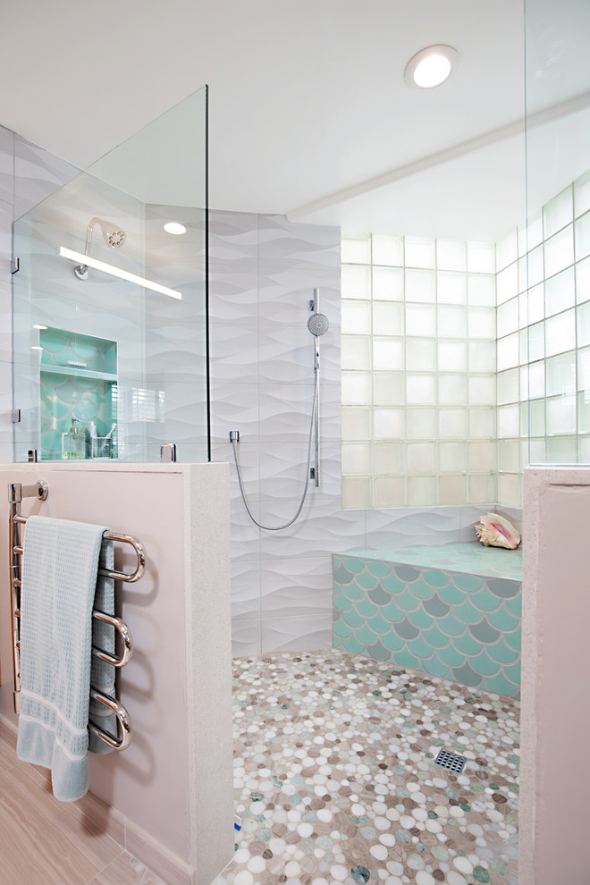 Inspiration for a large beach style master bathroom in San Diego with flat-panel cabinets, light wood cabinets, a double shower, a two-piece toilet, gray tile, porcelain tile, grey walls, porcelain floors, a vessel sink, engineered quartz benchtops, beige floor, an open shower and white benchtops.