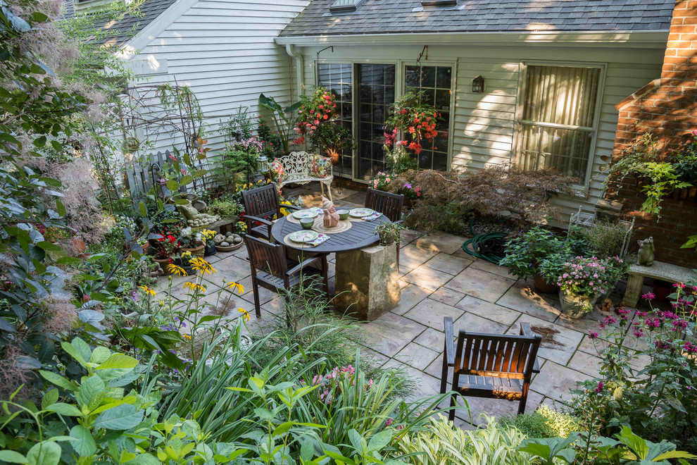 Inspiration for a small eclectic backyard partial sun formal garden in Cleveland with concrete pavers.