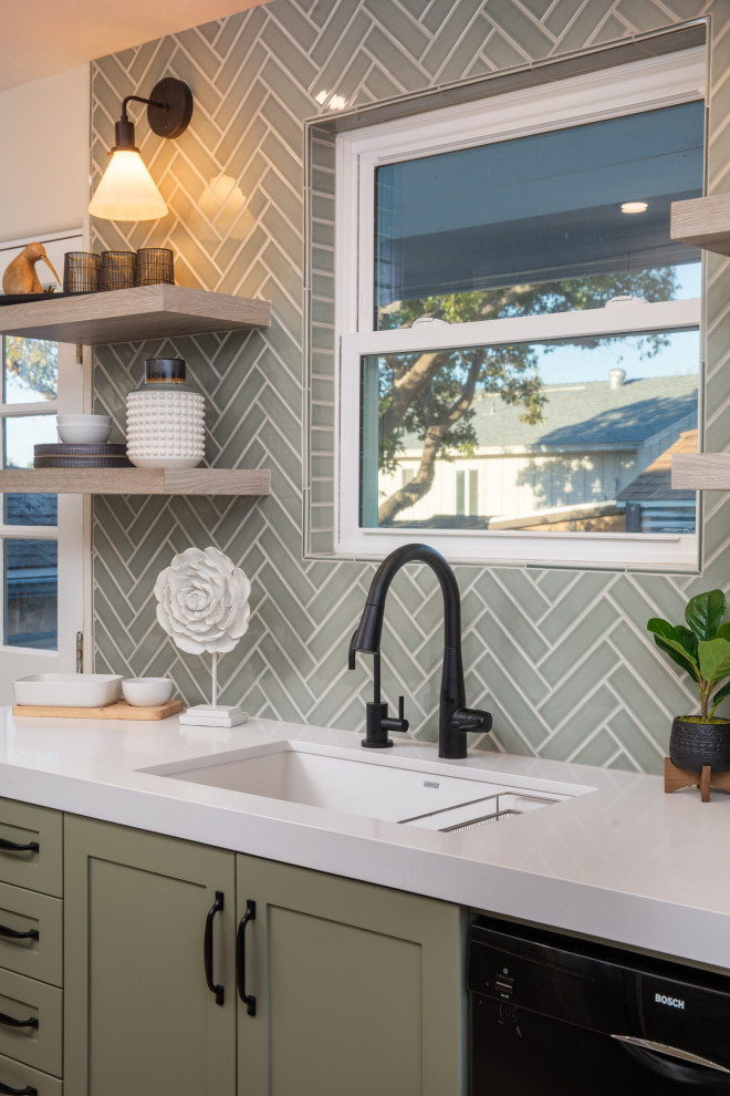 Design ideas for a mid-sized transitional u-shaped eat-in kitchen in San Diego with an undermount sink, shaker cabinets, green cabinets, quartz benchtops, green splashback, ceramic splashback, stainless steel appliances, vinyl floors, no island, grey floor and white benchtop.