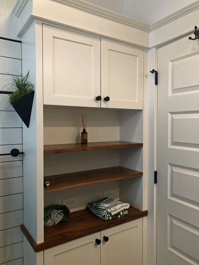 This is an example of a small industrial bathroom in Portland with shaker cabinets, white tile, subway tile, white walls, wood benchtops, brown benchtops and decorative wall panelling.