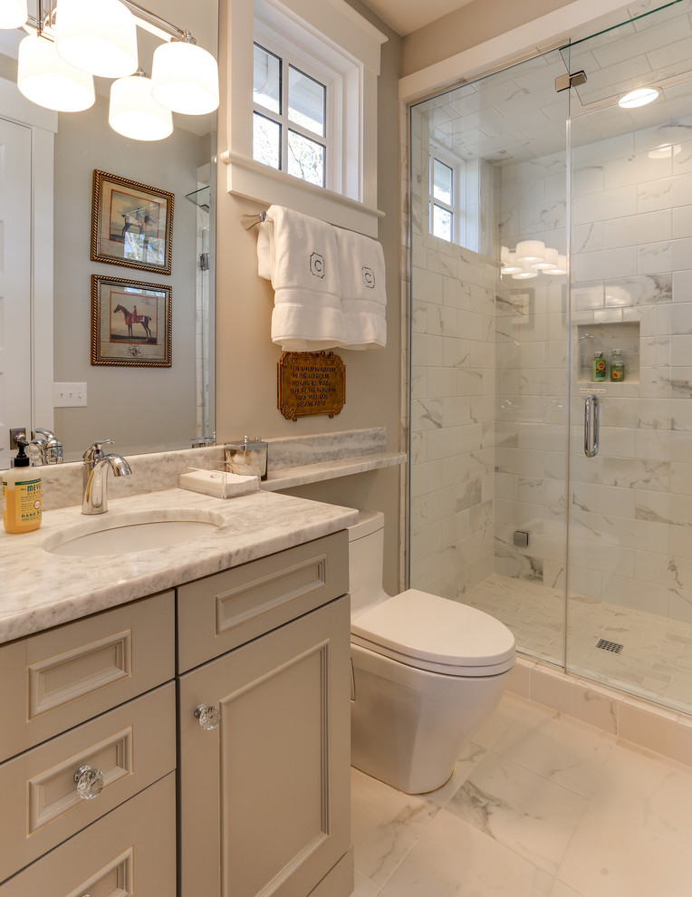 Inspiration for a small traditional 3/4 bathroom in Raleigh with recessed-panel cabinets, grey cabinets, an alcove shower, a two-piece toilet, yellow tile, stone tile, beige walls, ceramic floors, an undermount sink and marble benchtops.