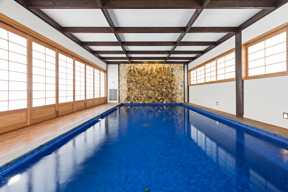 Photo of a large asian indoor rectangular lap pool in Melbourne with decking.
