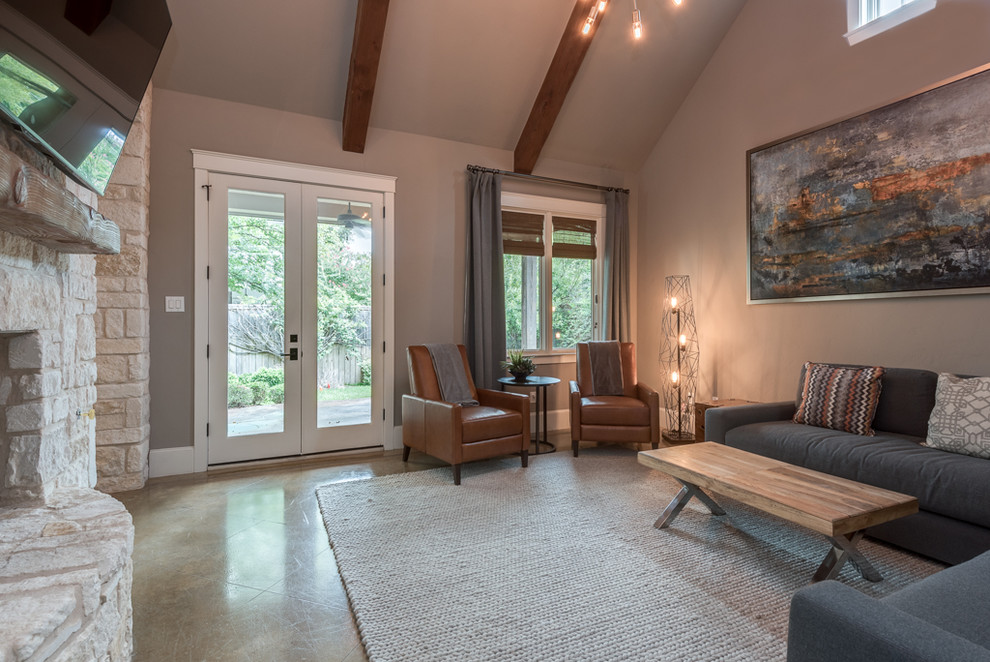 This is an example of a mid-sized transitional open concept family room in Dallas with concrete floors, a two-sided fireplace, a stone fireplace surround, a wall-mounted tv and beige walls.