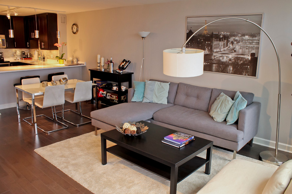Example of a mid-sized minimalist open concept dark wood floor living room design in Chicago with beige walls, no fireplace and a tv stand